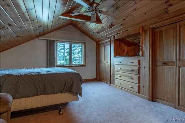 bedroom with baseboards, light colored carpet, wood ceiling, ceiling fan, and vaulted ceiling