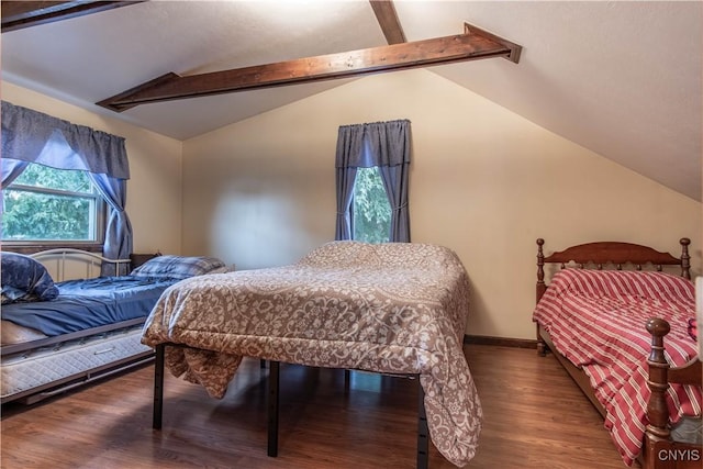 bedroom featuring lofted ceiling with beams, baseboards, and wood finished floors