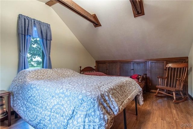 bedroom featuring lofted ceiling and wood finished floors