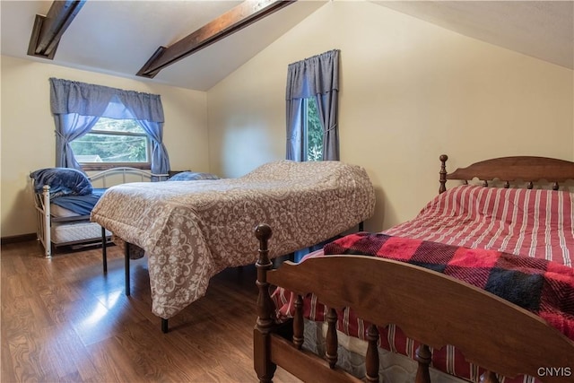 bedroom with lofted ceiling and wood finished floors