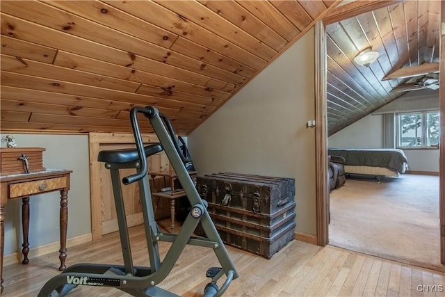 workout room with wooden ceiling, light wood-style floors, baseboards, and vaulted ceiling