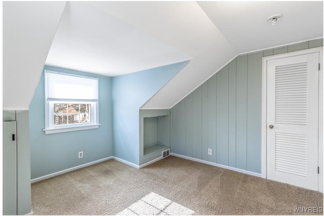 bonus room with visible vents, baseboards, carpet, and vaulted ceiling