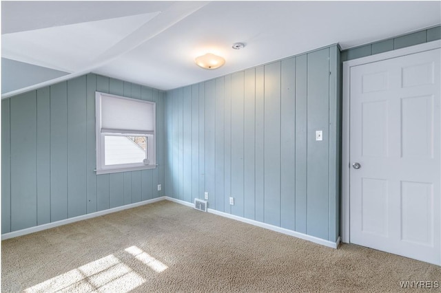 interior space featuring visible vents, baseboards, and carpet