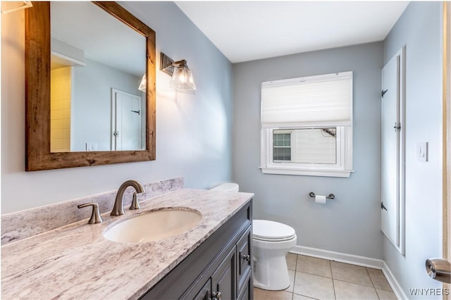 bathroom featuring baseboards, toilet, vanity, and tile patterned flooring