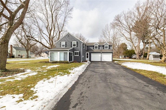 view of front of house with aphalt driveway and a garage