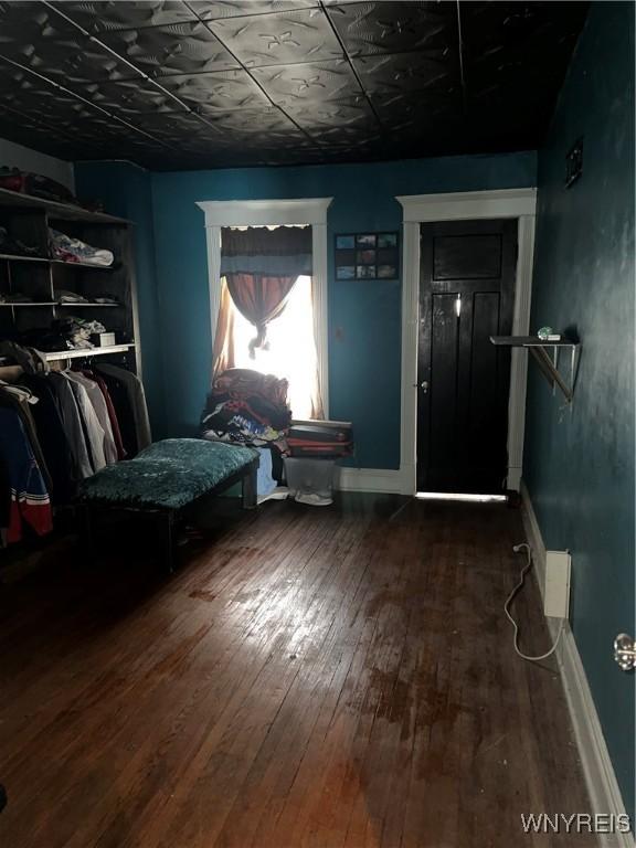 bedroom featuring baseboards and hardwood / wood-style floors