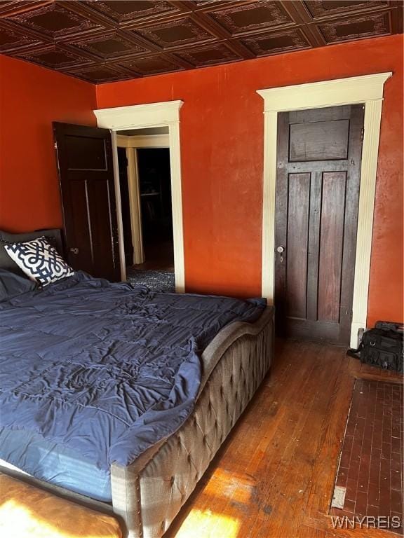 bedroom featuring an ornate ceiling and hardwood / wood-style flooring