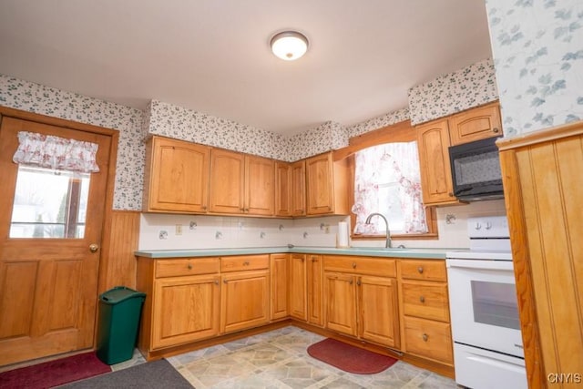 310 E German St, Herkimer, NY 13350 - kitchen with black microwave, a sink, wallpapered walls, and white range with electric cooktop