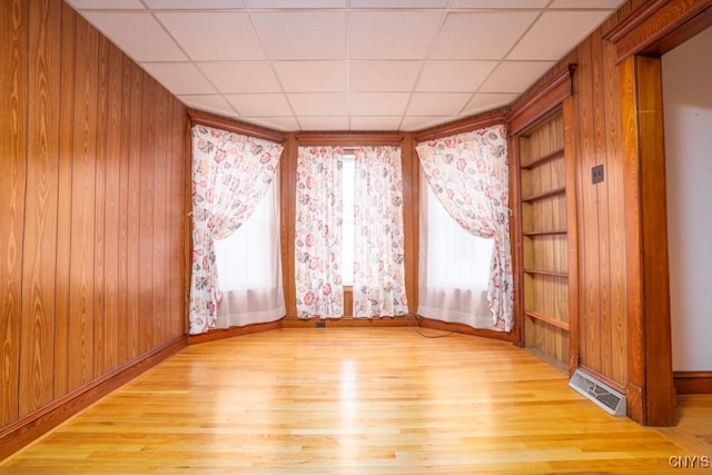 310 E German St, Herkimer, NY 13350 - spare room with wooden walls, visible vents, built in features, and light wood-style floors