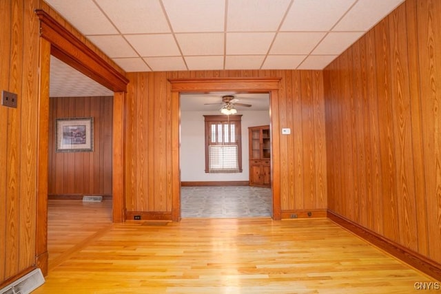 310 E German St, Herkimer, NY 13350 - unfurnished room with wood walls, light wood finished floors, a drop ceiling, and visible vents