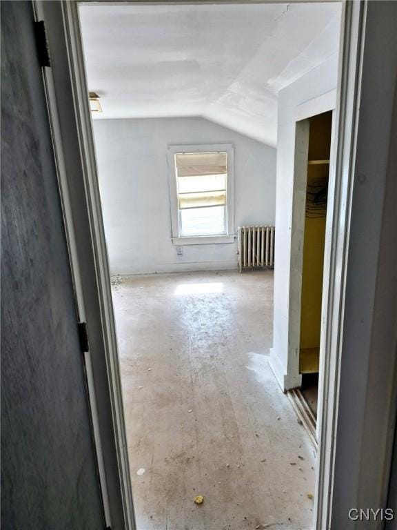 corridor with radiator heating unit and lofted ceiling