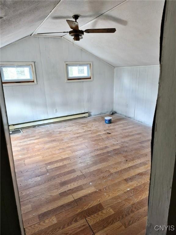 empty room with wood-type flooring, plenty of natural light, and a ceiling fan