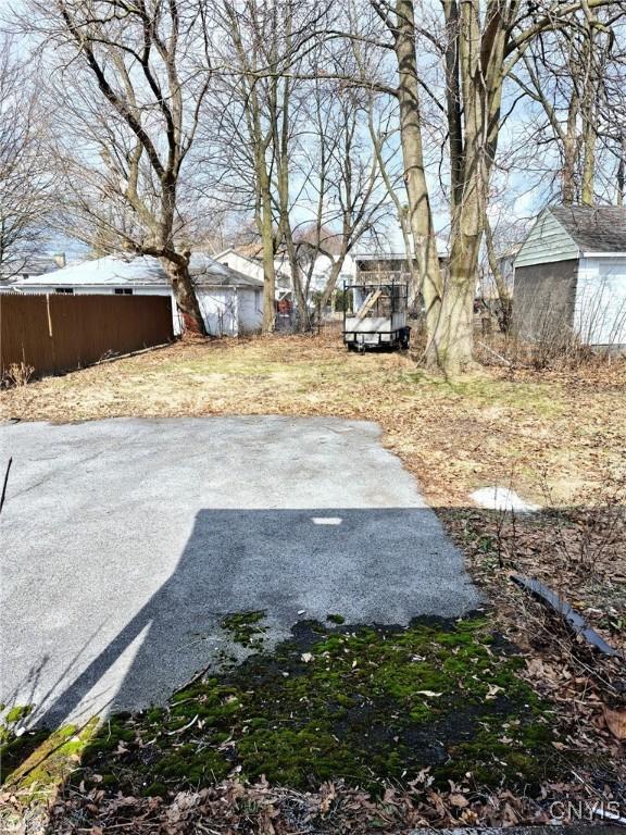 view of yard with an outbuilding and a storage shed