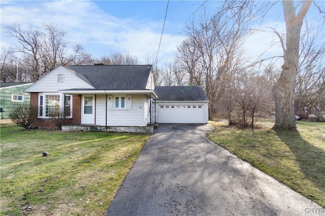 view of front of property featuring brick siding, roof with shingles, and a front lawn