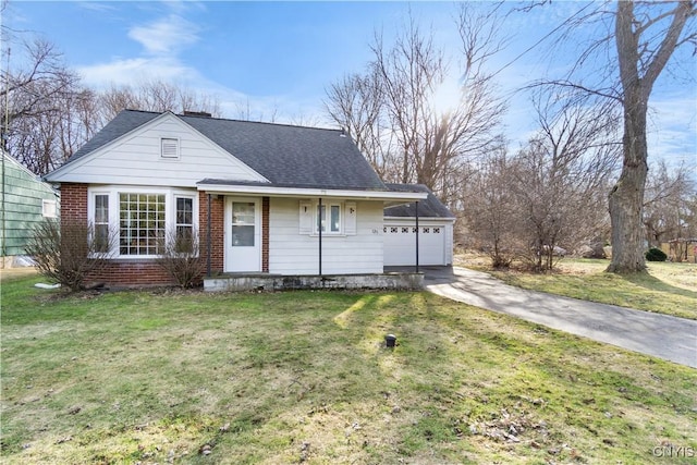 view of front facade with a front lawn, a garage, brick siding, and a shingled roof