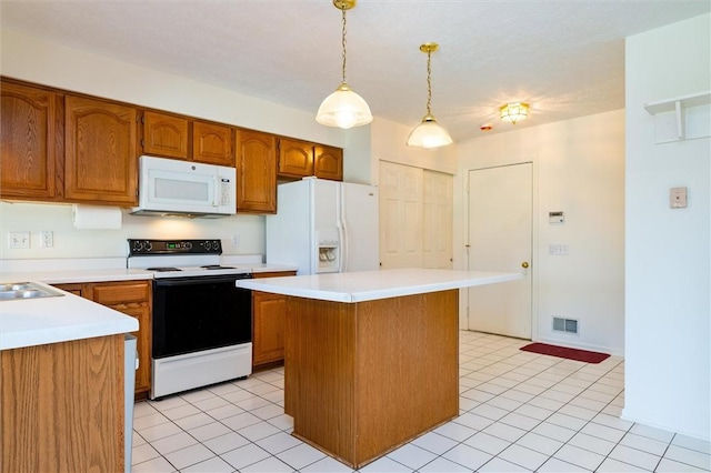 kitchen featuring visible vents, white appliances, brown cabinets, and light countertops