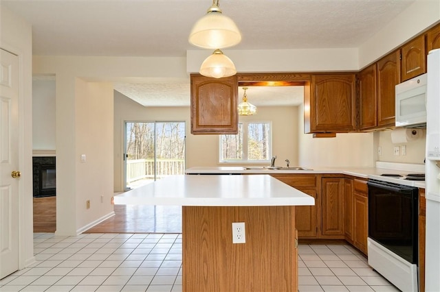 kitchen with light countertops, light tile patterned flooring, white microwave, and range with electric cooktop