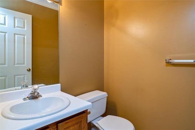 bathroom featuring toilet and vanity