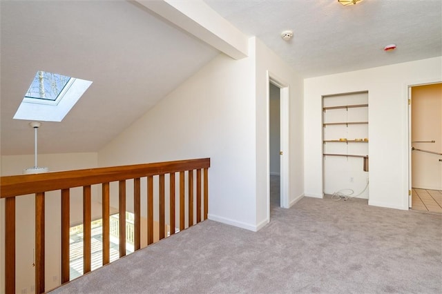 bonus room featuring lofted ceiling with skylight, baseboards, and carpet floors