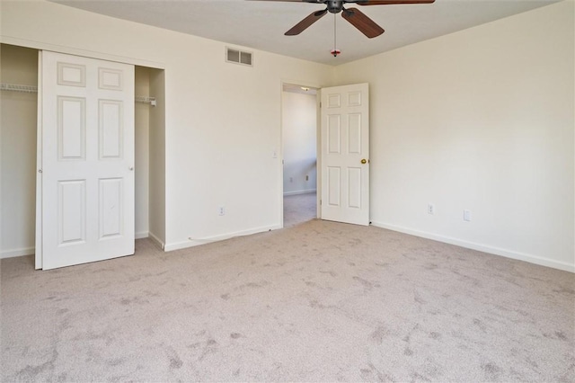 unfurnished bedroom with visible vents, a closet, carpet flooring, baseboards, and ceiling fan