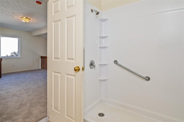 full bath featuring a shower and a textured ceiling