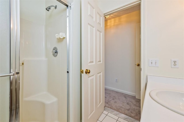 bathroom with tile patterned floors, vanity, and a shower stall