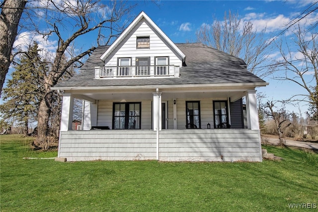 view of front of property with a porch, a front lawn, a balcony, and roof with shingles