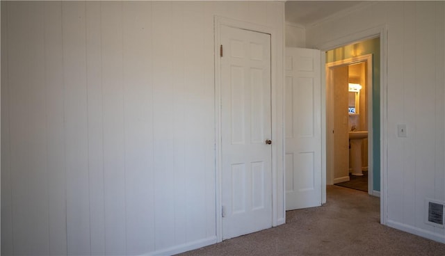 unfurnished bedroom featuring visible vents, baseboards, and carpet floors