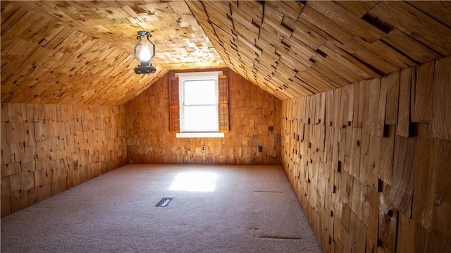 additional living space featuring visible vents, carpet floors, wood walls, wood ceiling, and vaulted ceiling