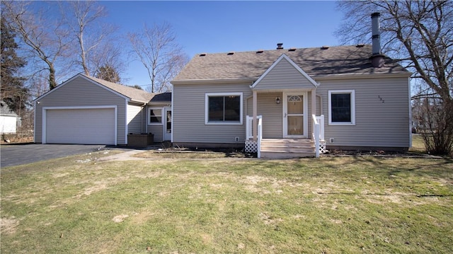 bungalow-style house featuring a detached garage and a front lawn