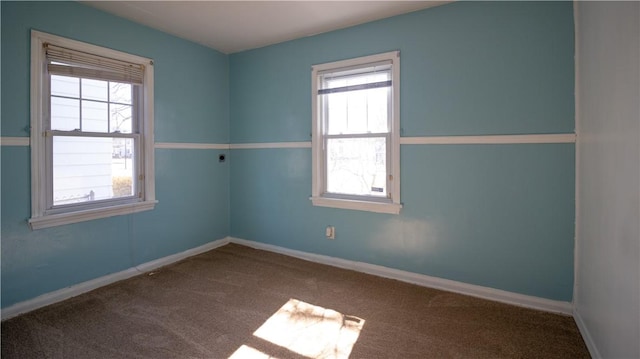 unfurnished room featuring baseboards and carpet floors