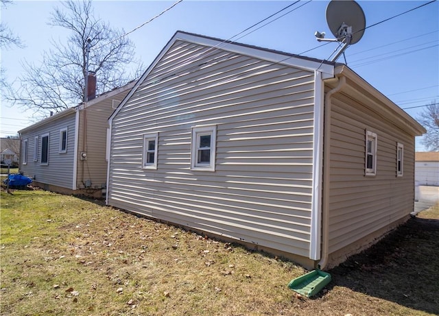 view of side of home featuring a yard