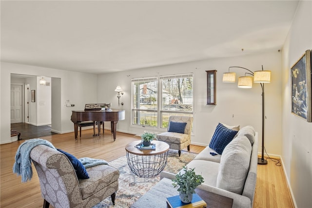 living room featuring baseboards and light wood-type flooring