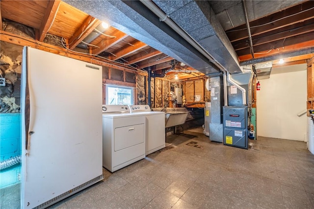 interior space featuring washer and dryer, a sink, laundry area, and tile patterned floors