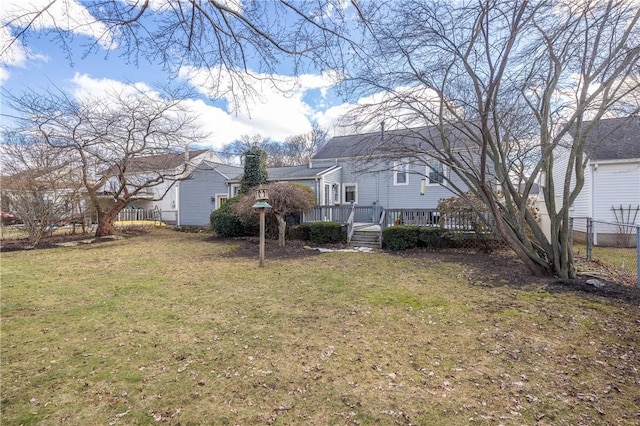 view of yard with a deck and fence