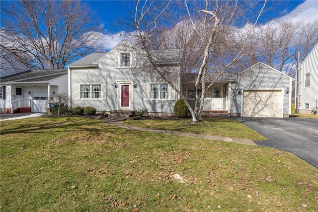 view of front facade featuring aphalt driveway, a garage, and a front yard