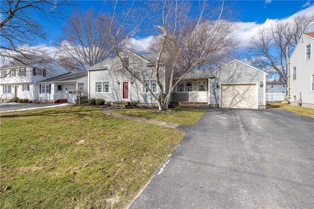 view of front facade featuring a garage, a residential view, a front lawn, and driveway