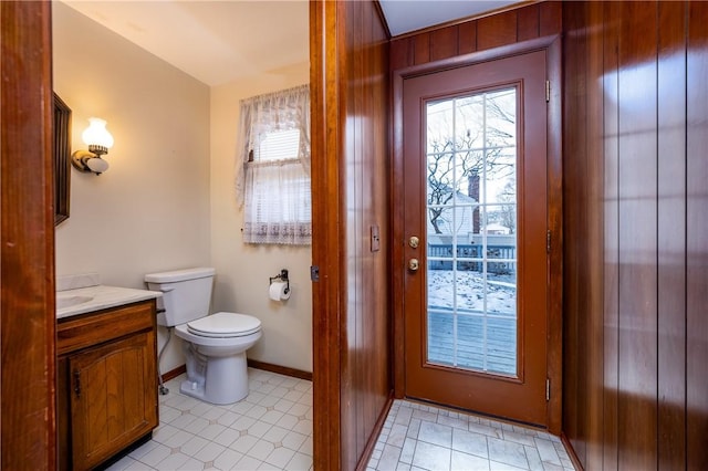 bathroom featuring vanity, toilet, and baseboards