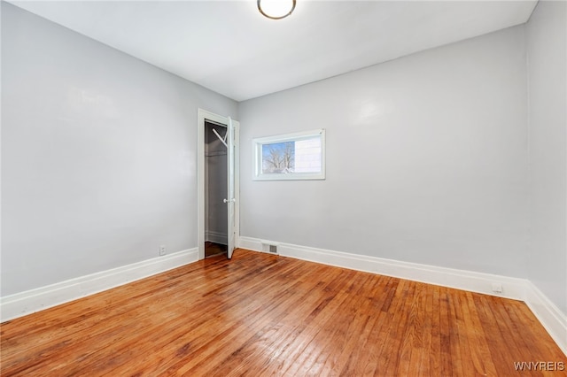 unfurnished room featuring baseboards and light wood-style floors