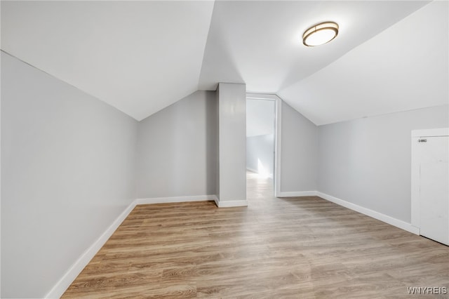 bonus room featuring lofted ceiling, wood finished floors, and baseboards