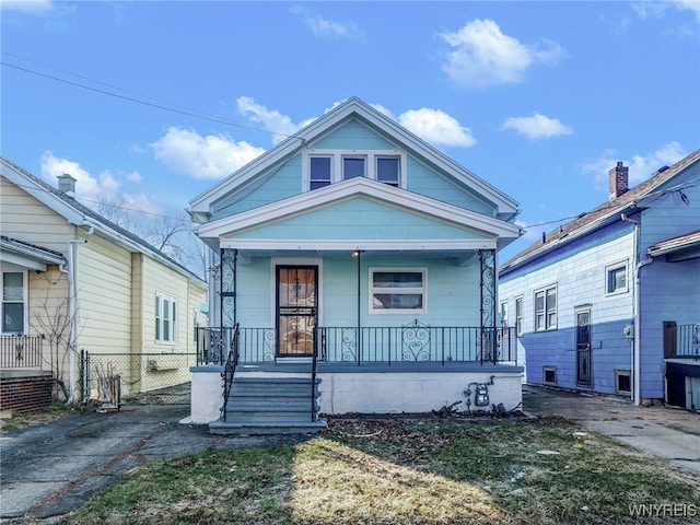 view of front of house featuring a porch and fence