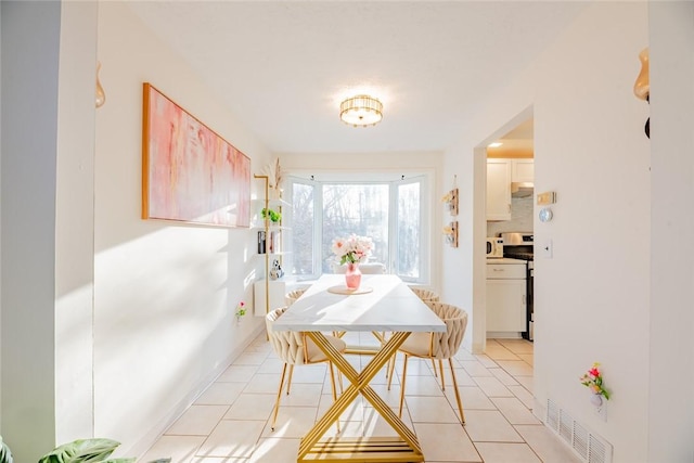 dining room featuring light tile patterned flooring and visible vents