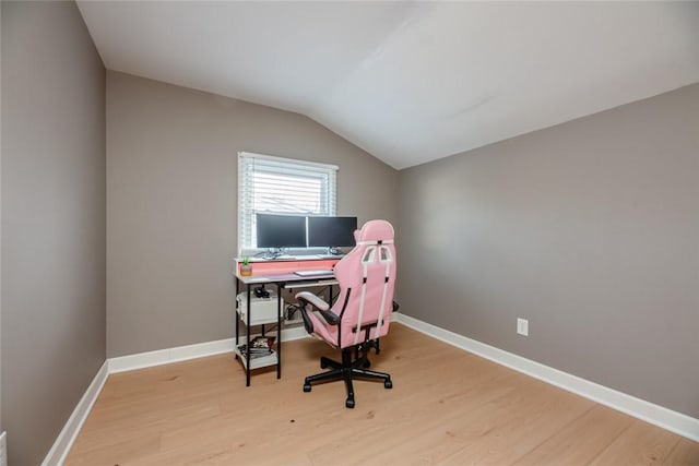 office area featuring vaulted ceiling, wood finished floors, and baseboards