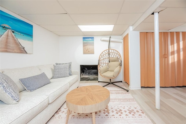 living room featuring a drop ceiling and wood finished floors