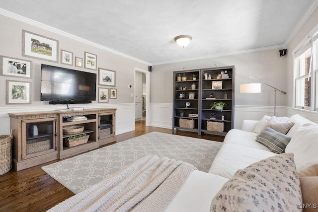 living room with a wainscoted wall, crown molding, and wood finished floors