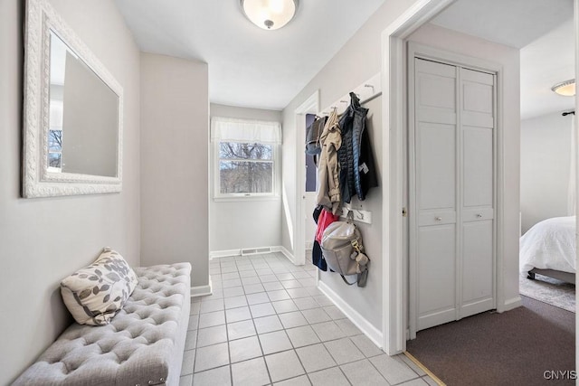 mudroom with light tile patterned floors and baseboards