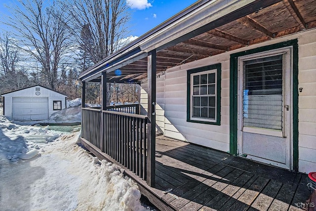 wooden deck with an outbuilding and a detached garage