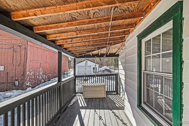 snow covered deck with an outbuilding