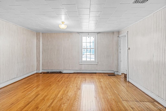 empty room featuring visible vents and light wood-style floors