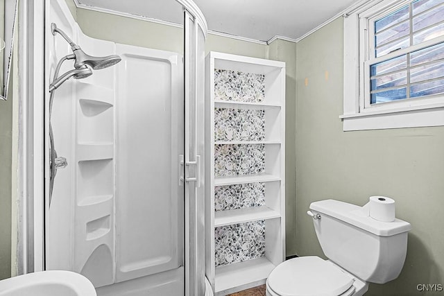 bathroom with a shower stall and toilet